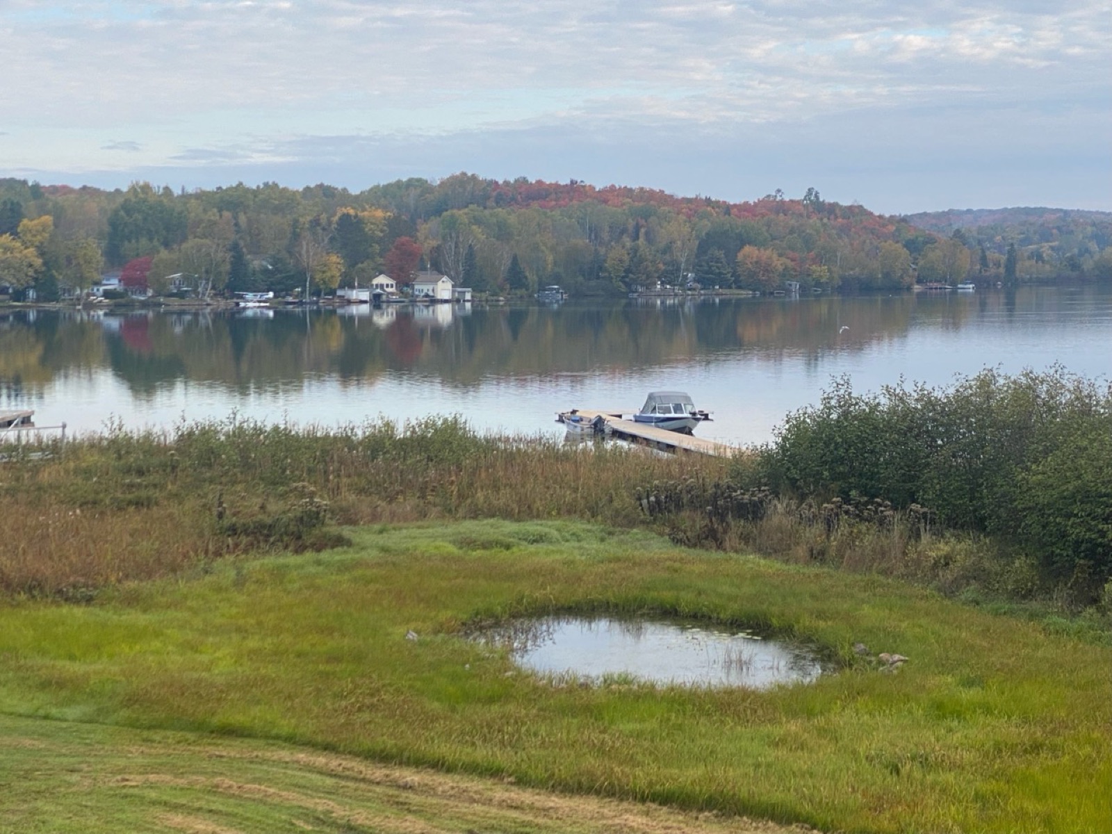 Autumn colours reflected on Lake Nosbonsing beside the private dock