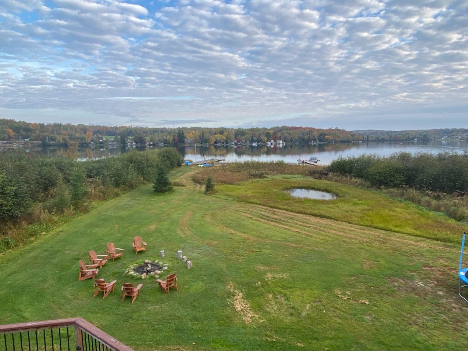 The large cottage lawn and firepit overlooking the lake in autumn
