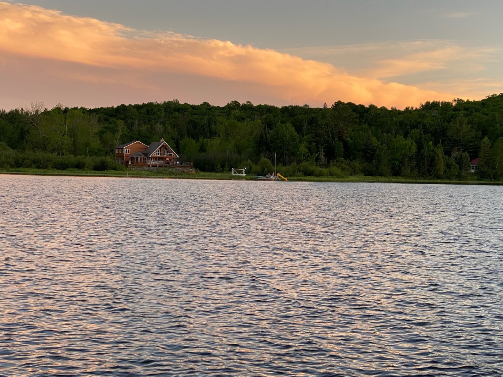 Wide sunset view of the cottage from the water
